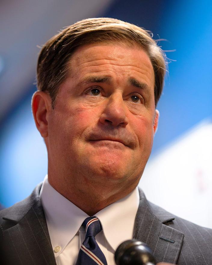 After a ribbon-cutting ceremony, Governor Doug Ducey answers questions from reporters at the Arizona Counter Terrorism and Information Center in Phoenix on October 4, 2021.