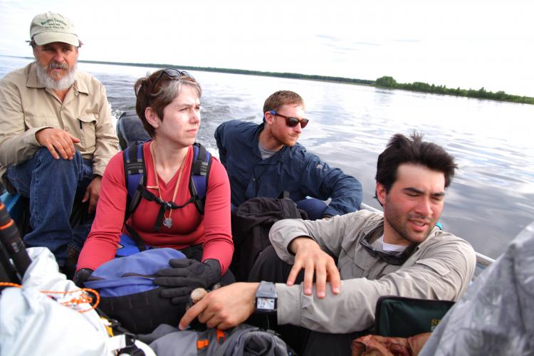 Image of four people in a boat.