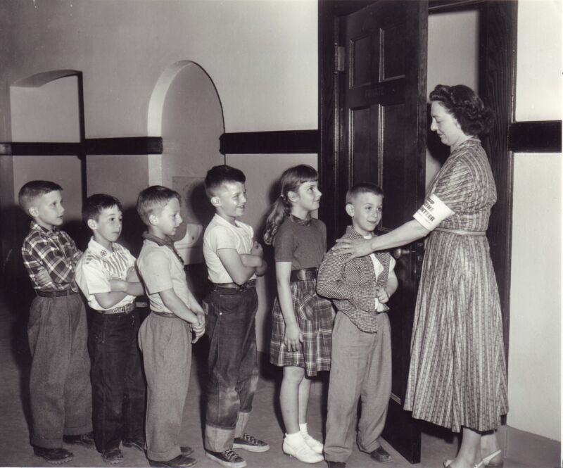 Children line up to get their polio vaccine at Woodbury Avenue School in Huntington, New York, on April 27, 1954.