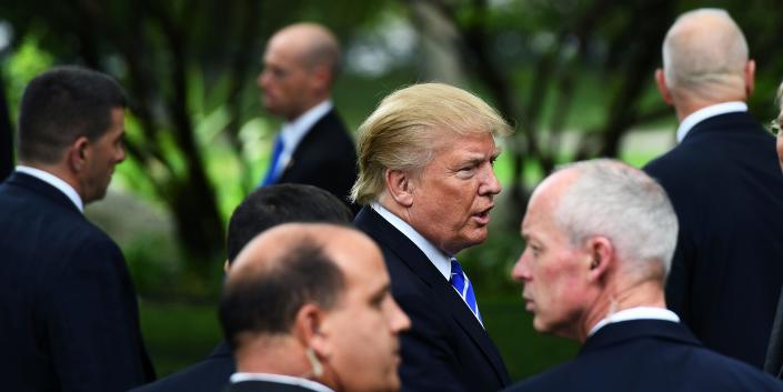US Republican presidential candidate Donald Trump (C) is surrounded by members of the Secret Service as he visits the grave of former US President Gerald Ford in Grand Rapids, Michigan, on September 30, 2016.