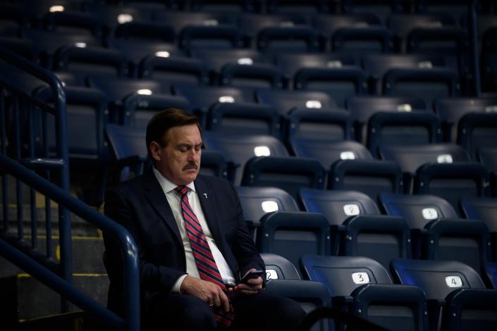 Mike Lindell, CEO of MyPillow, checks his cell phone at the Covelli Center for a Save America Rally, featuring former President Donald Trump, to support Republican candidates running for state and federal offices on September 17, 2022 in Youngstown, Ohio .