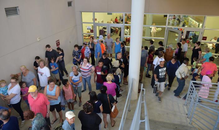 People queue for breakfast served at the disaster shelter at Riverview High School in Sarasota ahead of Hurricane Irma in 2017. The shelter quickly reached capacity and closed to new evacuees.  Sarasota County is in the process of hardening schools in the middle of the county into storm shelters.