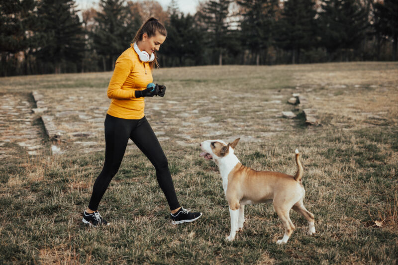 Teen plays fetch with her dog