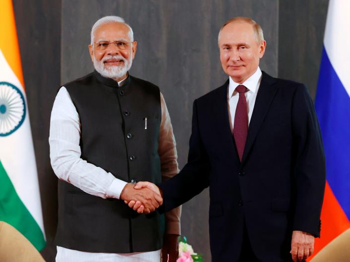 Russian President Vladimir Putin, right, and Indian Prime Minister Narendra Modi pose for a photo shaking hands ahead of their talks on the sidelines of the Shanghai Cooperation Organization (SCO) summit in Samarkand, Uzbekistan, Friday, September 16, 2022.