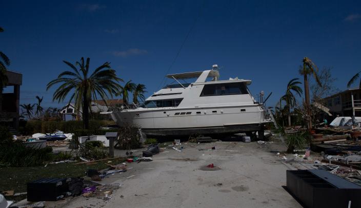 A boat lies on a road on San Carlos Island on Thursday after Hurricane Ian made landfall.  