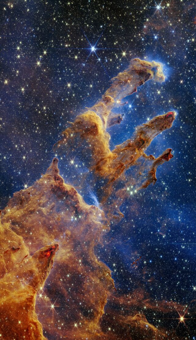 The Pillars of Creation can be seen in a kaleidoscope of colors in the near-infrared light image from the James Webb Space Telescope. 