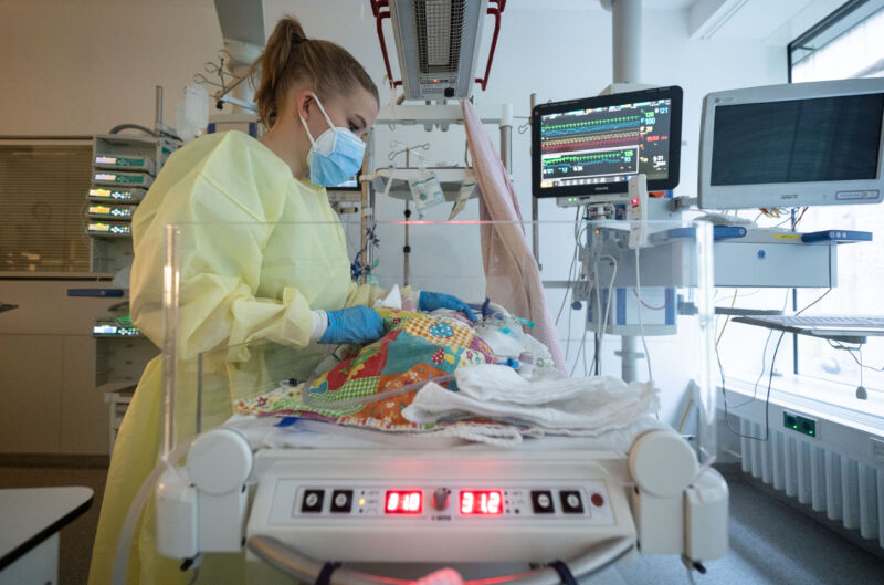 An intensive care nurse cares for a patient suffering from the respiratory syncytial virus.