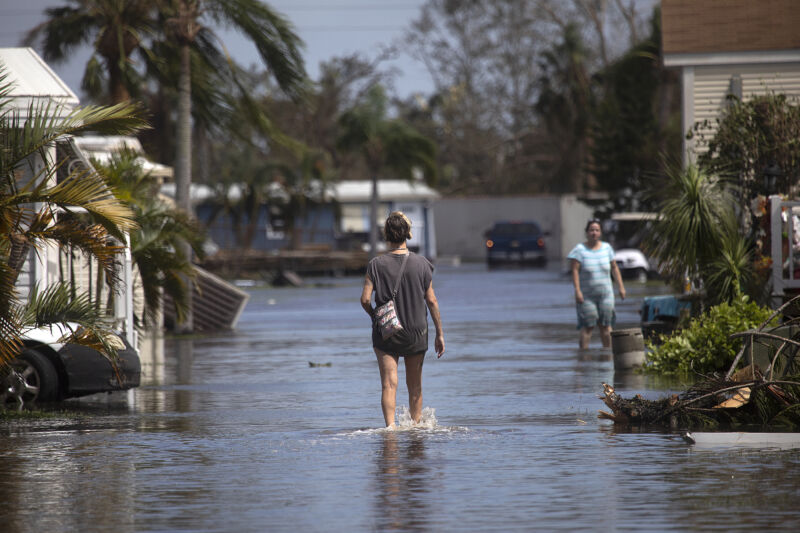 A resident of the Gulf Air mobile home park walks through the waters of Hurricane Ian through her neighborhood near Fort Myers Beach on Sept. 29. 