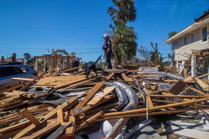 Members of the Miami search and rescue team, including Pasco, a black Labrador retriever, are searching the rubble for missing persons on Fort Myers Beach two days after Hurricane Ian hit Florida's west coast as a Category 4 storm.