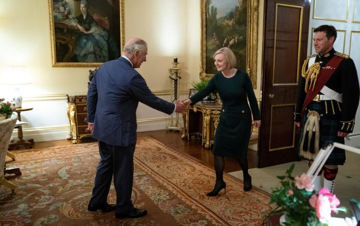 King Charles shakes hands with Liz Truss during their weekly audience at Buckingham Palace in London on Wednesday - REUTERS