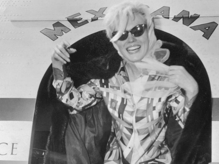 Monroe arrives on a plane from Mexico City.