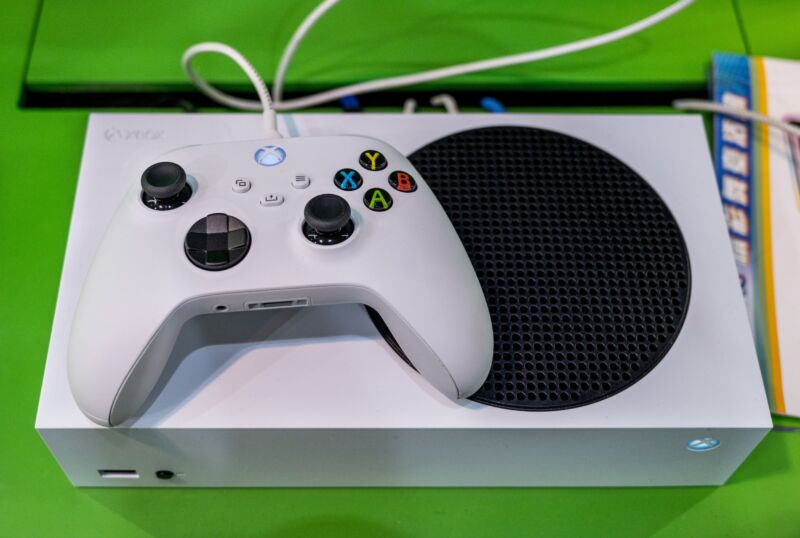 An Xbox controller on top of an Xbox Series S console.