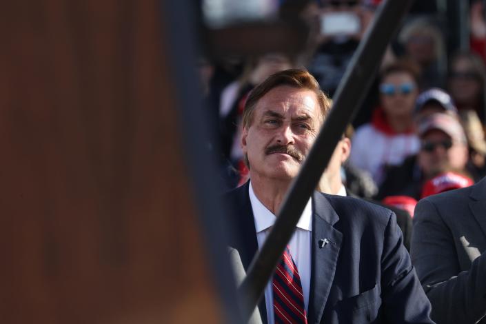 Mike Lindell, CEO of My Pillow, listens as former President Donald Trump addresses supporters at a rally at I-80 Speedway on May 1, 2022 in Greenwood, Nebraska.  Trump backs Charles Herbster in Nebraska governor race.