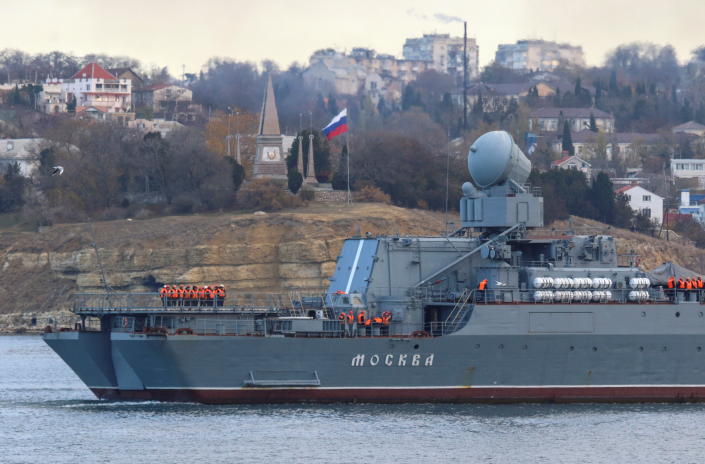 Russian naval officers line up on deck as the guided-missile cruiser Moskva (Moscow) sails back to a port after tracking NATO warships in the Black Sea, in the port of Sevastopol, Crimea Nov. 16, 2021. REUTERS/Alexey Pavlishak