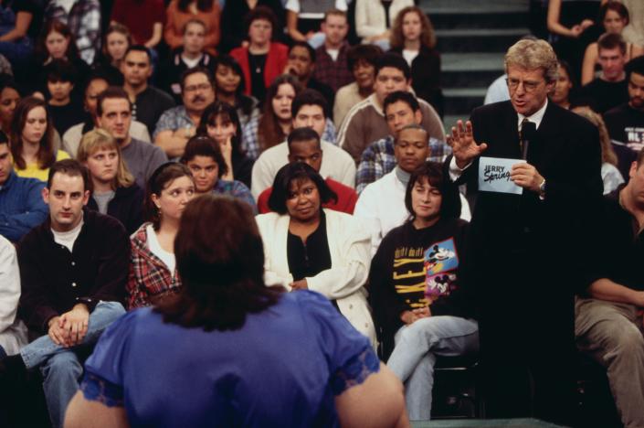 Jerry Springer talks to his guests and audience on the set of The Jerry Springer Show.