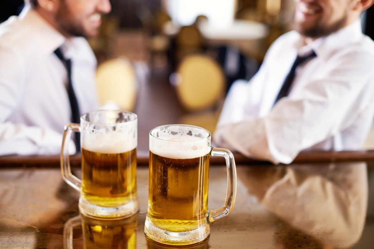 Men in the bar with beer glasses on the table