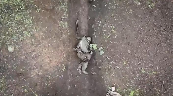 A screenshot of a video showing grenades being dropped on a Russian soldier.