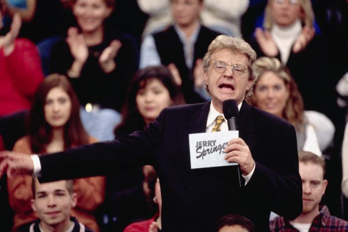 Jerry Springer talks to his guests and audience on the set of The Jerry Springer Show.