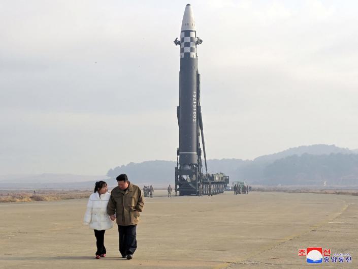 Kim Jong-un walks with a young girl whom the North Korean news has identified as his daughter.