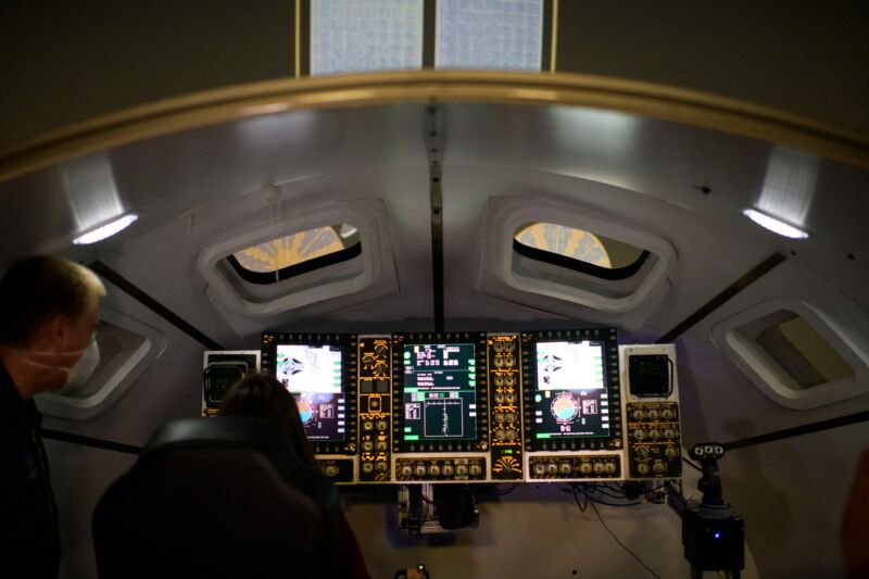 People watch in an Orion spacecraft simulator, used to train for docking with the Gateway space station, at the Johnson Space Center's System Engineering Simulator facility in Houston.