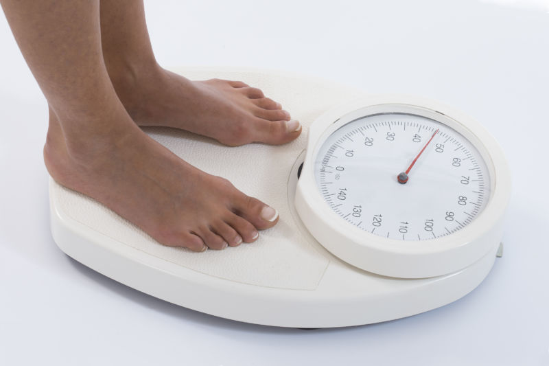 Woman on a weighing scale of kg 