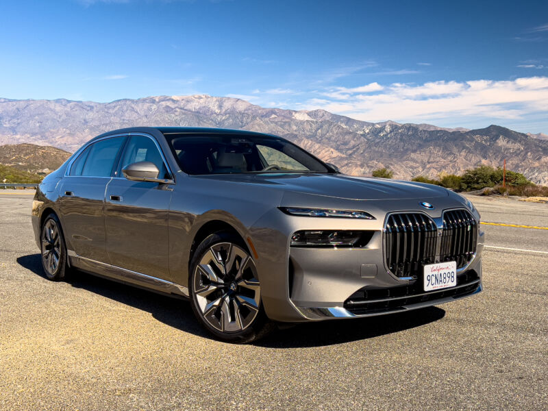 A BMW i7 with mountains in the background