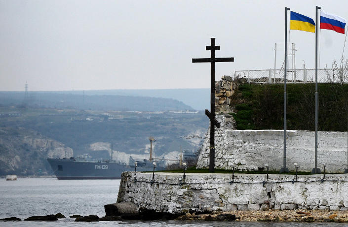 The Russian and Ukrainian flags flutter in the port of Sevastopol on March 8, 2014.  The Organization for Security and Co-operation in Europe said its observers would attempt to re-enter the Ukraine region of Crimea on March 8, two days after being prevented from entering.  of doing this.  On March 6, the Vienna-based OSCE said its team had been prevented from entering Ukraine's strategic Black Sea peninsula, with a Western diplomatic source telling AFP they had been turned back by gunmen.  AFP PHOTO / FILIPPO MONTEFORTE (Photo credit must read FILIPPO MONTEFORTE/AFP via Getty Images)