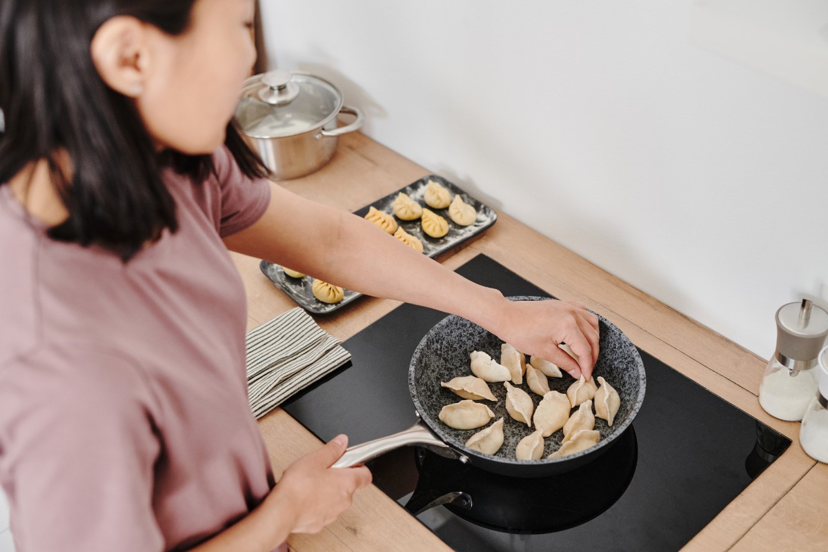 A woman cooking dumplings