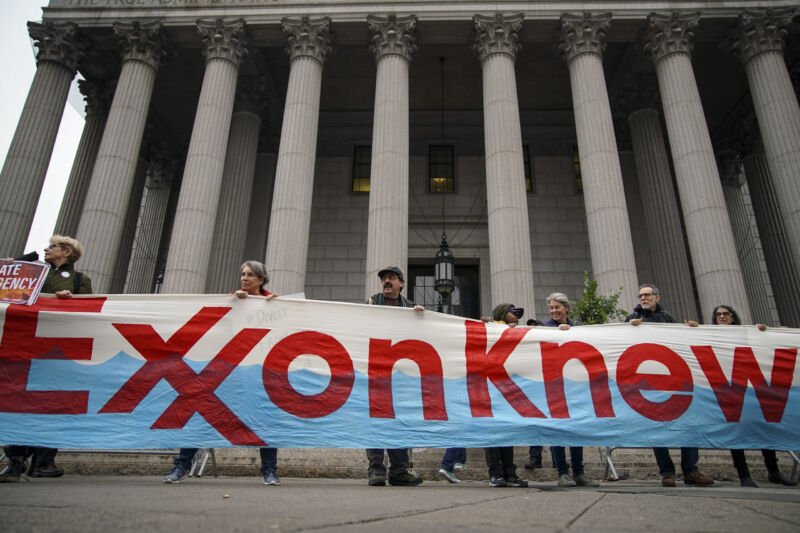 Environmentalists gather in New York City on October 22, 2019 for accountability for fossil fuel companies outside the New York Supreme Court.