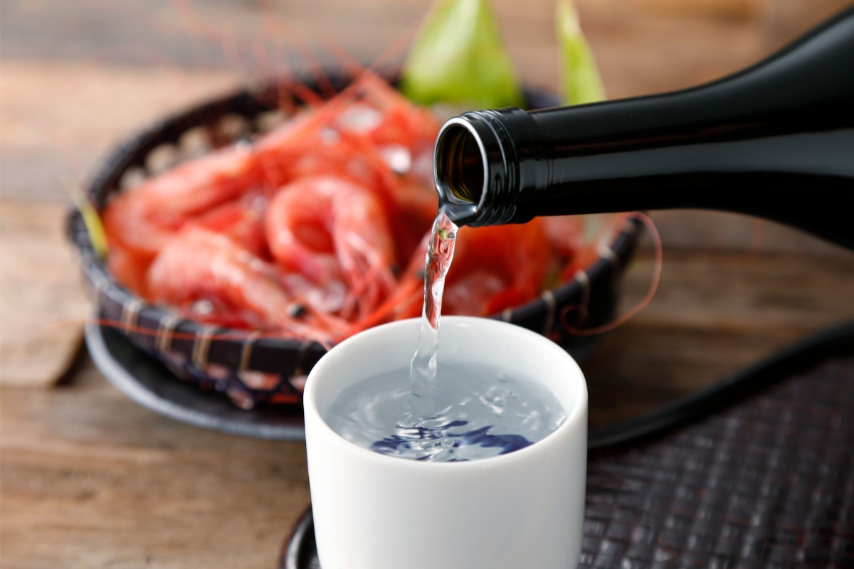 Pour sake into a cup