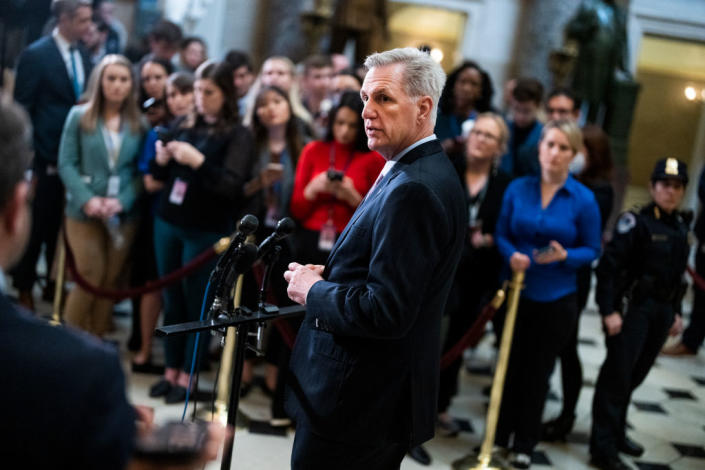 Speaker Kevin McCarthy stands by a set of microphones at a press conference.