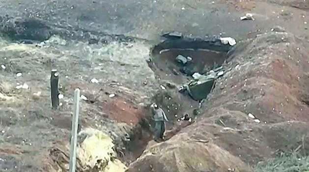 An image taken by a Ukrainian drone shows a Russian soldier peering at the sky from a front-line trench near the eastern Ukrainian city of Bakhmut just before a shell lands in the trench in late January 2023.  / Credit: Handout/Ukrainian Armed Forces