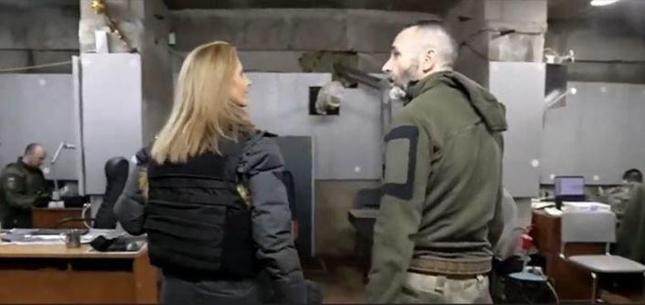 Seva Kozhemyako, founder and commander of the Ukrainian Armed Forces' Khartia Battalion, leads CBS News' Debora Patta to an underground bunker in Bakhmut, eastern Ukraine, where volunteers monitor screens where video is streamed live by drones over the front lines.  / Credit: CBS News