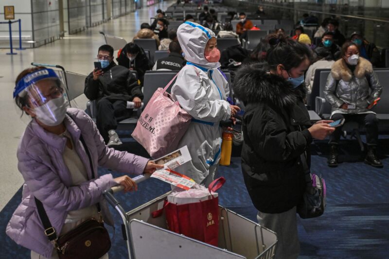 A passenger wearing protective gear during the COVID-19 pandemic waits to board a domestic flight at Shanghai Pudong International Airport on January 3. 