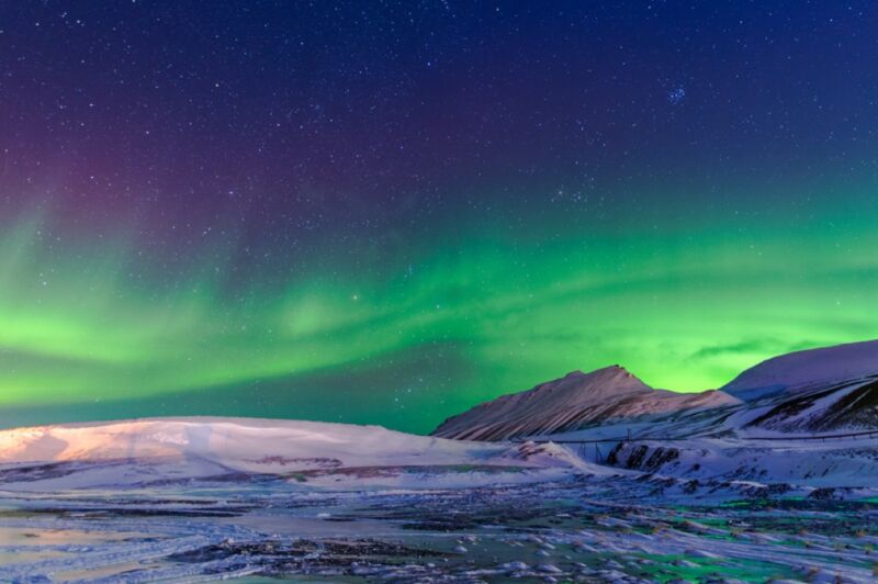 Northern lights over snow-capped mountains in Hangzhou, China.