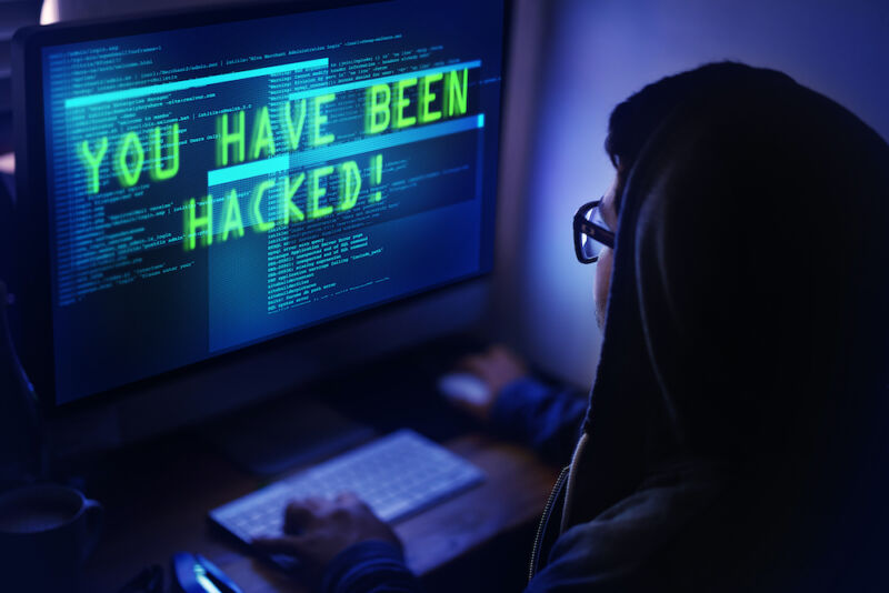 Shot of a person reading a hack message on her monitor 