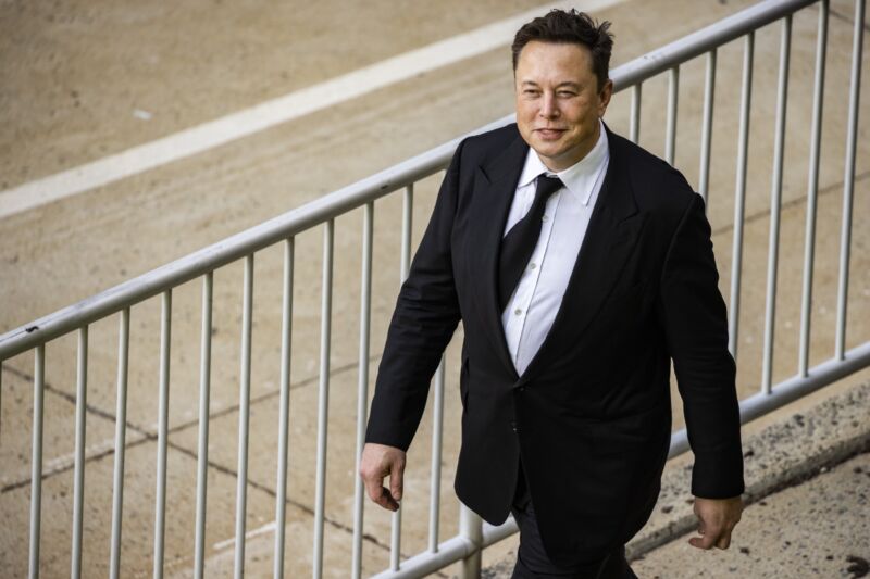 Elon Musk wears a suit as he exits a courthouse during a 2021 trial.