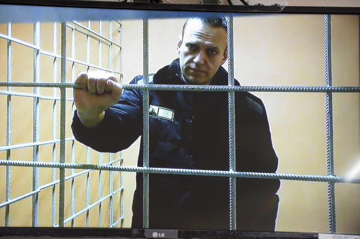 Russian opposition leader Alexei Navalny watches a camera from a prison cell.