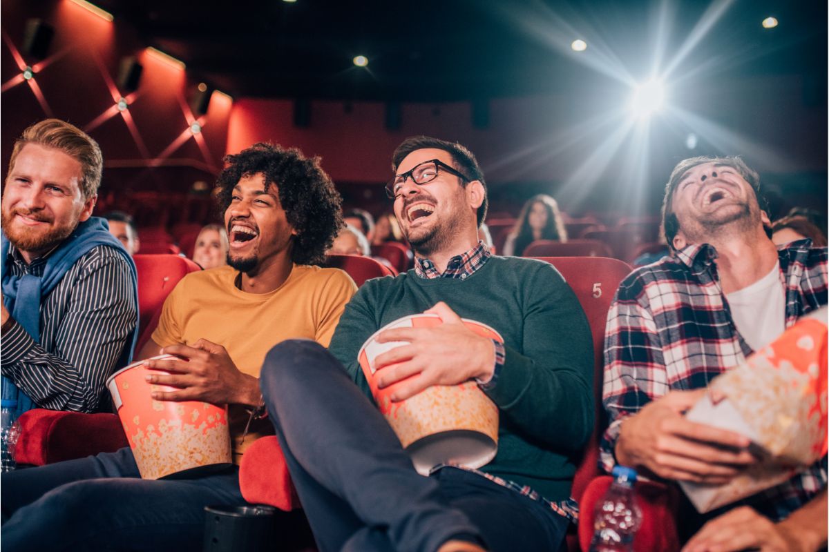 Men watching comedy movies in cinema