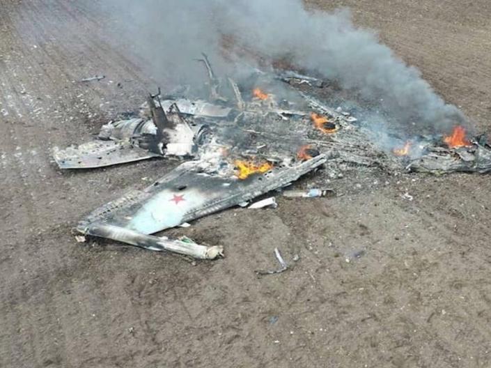 The smoking debris of a Russian Su-35 fighter jet that crashed in a field in Ukraine.