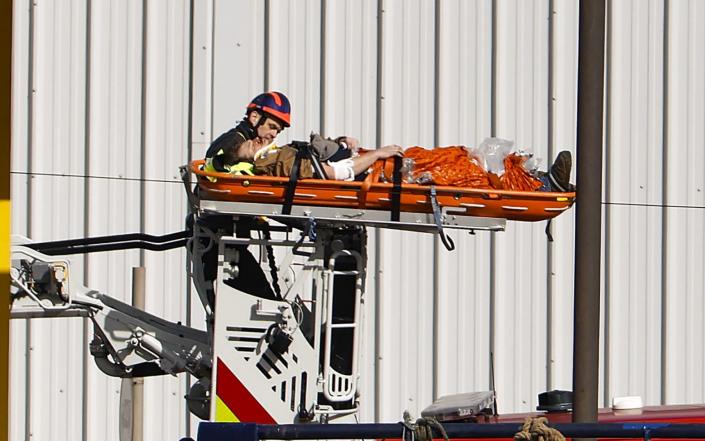 An injured man on a stretcher is helped by emergency services - Jeff J Mitchell/Getty Images