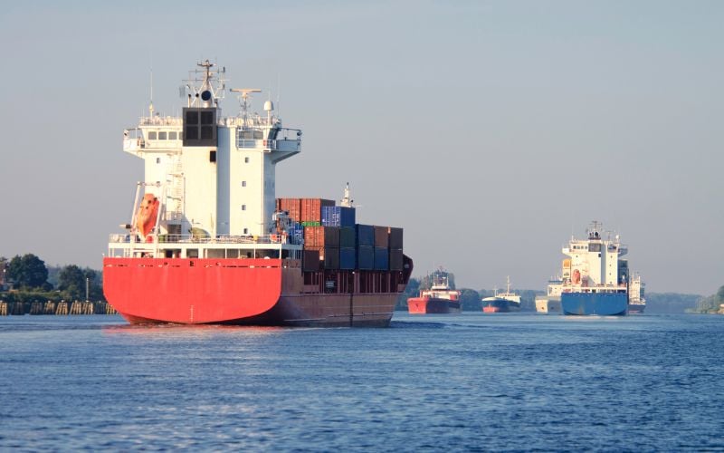 Sea ships at sea against a gray sky