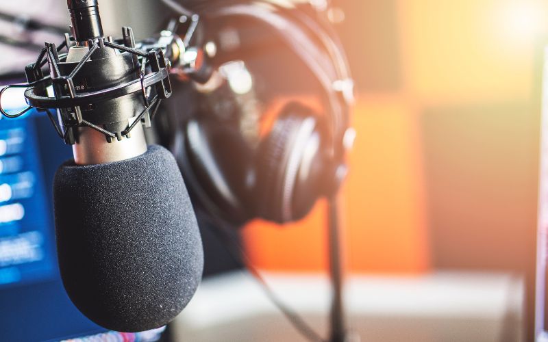 Radio microphone and headphones in a bright sunny UK radio studio