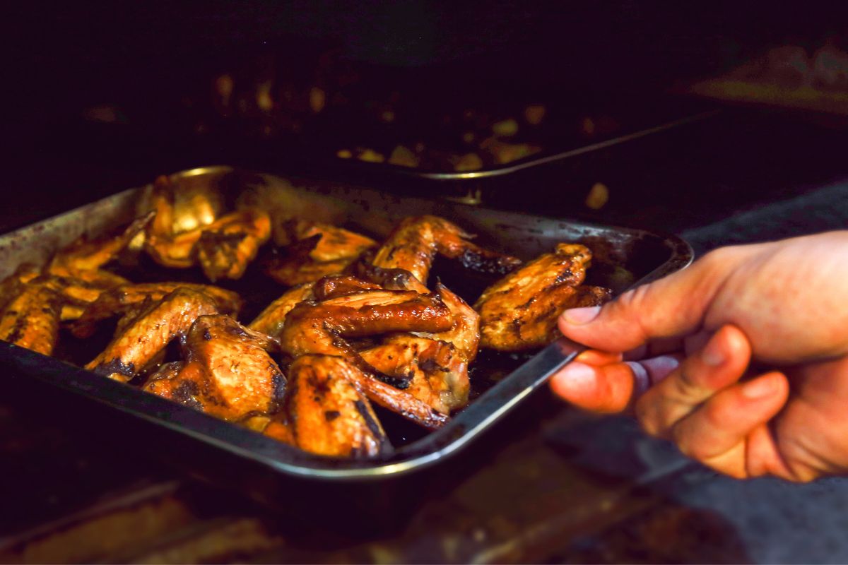 male chef cooking chicken wings