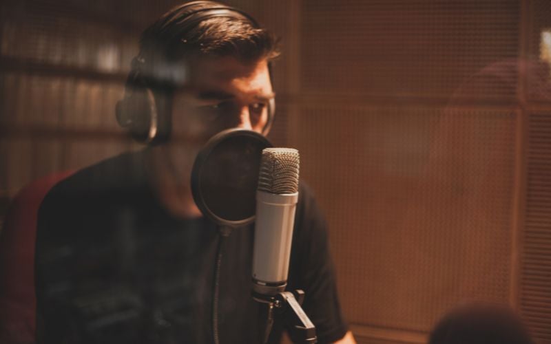 Man with headphones in front of a microphone in a radio station