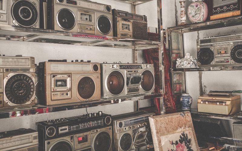 A room with shelves full of old radios and other antiques 