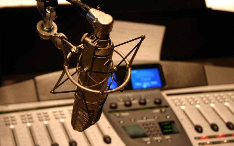 Close-up of a radio station's microphone and soundboard 