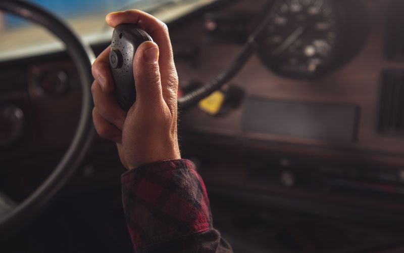 A man's hand on an airplane holds a comm during the war in Ukraine and Russia