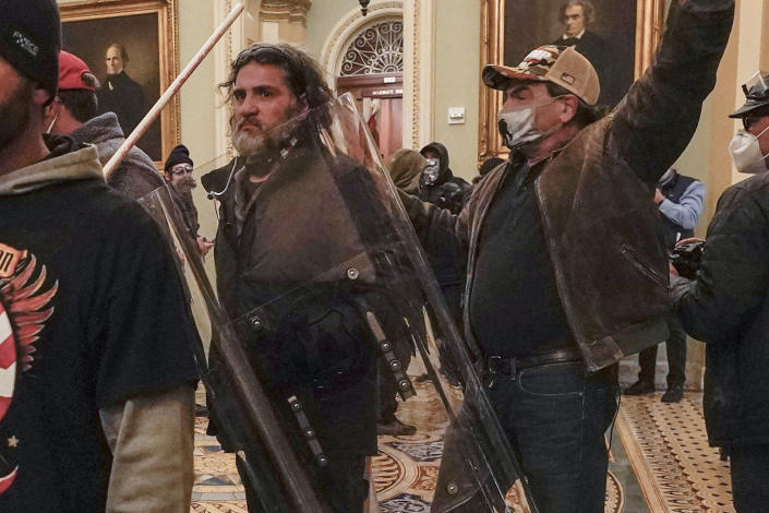 Rioters, including Dominic Pezzola, center, wearing police shield, are confronted by Capitol police officers outside the Senate Chamber in the Capitol on January 6, 2021. 