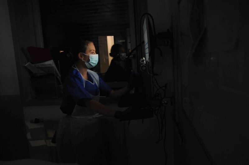 A healthcare worker in a medical intensive care unit.